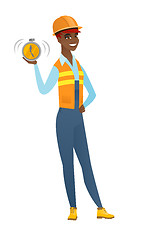 Image showing African-american builder holding alarm clock.