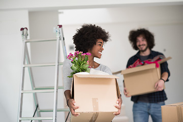 Image showing multiethnic couple moving into a new home