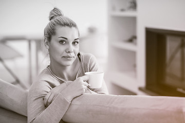 Image showing woman with a mug near a fireplace