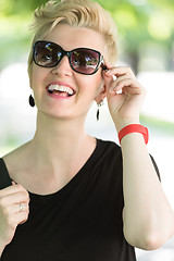 Image showing young woman with short blond hair and sunglasses