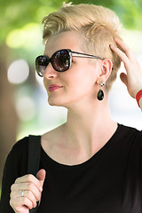 Image showing young woman with short blond hair and sunglasses