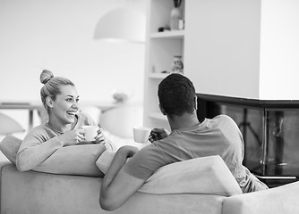 Image showing Young multiethnic couple  in front of fireplace