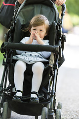 Image showing mother pushed her baby daughter in a stroller