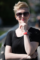 Image showing young woman with short blond hair and sunglasses