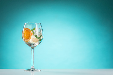 Image showing The rose exotic cocktail and fruit on blue