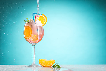 Image showing The rose exotic cocktail and fruit on blue