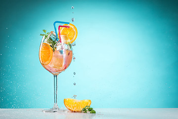 Image showing The rose exotic cocktail and fruit on blue