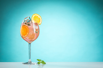 Image showing The rose exotic cocktail and fruit on blue