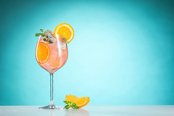 Image showing The rose exotic cocktail and fruit on blue