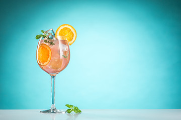 Image showing The rose exotic cocktail and fruit on blue