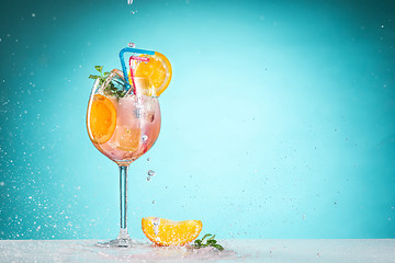 Image showing The rose exotic cocktail and fruit on blue