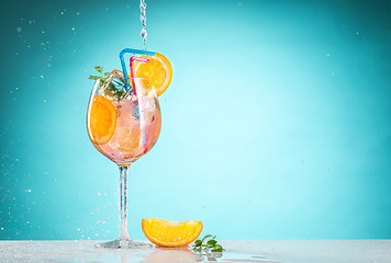 Image showing The rose exotic cocktail and fruit on blue