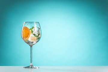 Image showing The rose exotic cocktail and fruit on blue