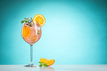 Image showing The rose exotic cocktail and fruit on blue