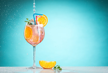 Image showing The rose exotic cocktail and fruit on blue