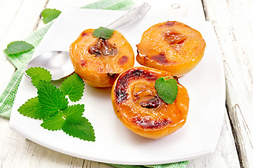 Image showing Quince baked with mint in plate on light board