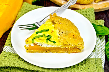 Image showing Pie of pumpkin and cheese in plate on green napkin