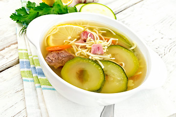 Image showing Soup with zucchini and noodles on light board