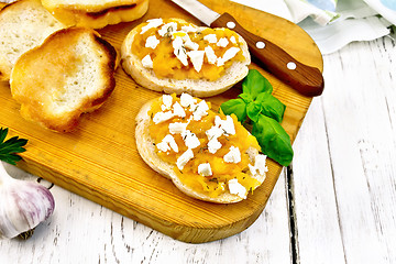 Image showing Bruschetta with pumpkin feta on board