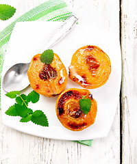 Image showing Quince baked with mint in plate on board top