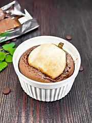 Image showing Cake with chocolate and pear in white bowl on board