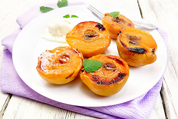 Image showing Quince baked with ice-cream in plate on board