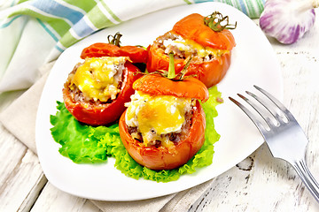 Image showing Tomatoes stuffed with rice and meat in plate on board