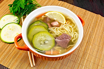 Image showing Soup with zucchini and noodles on bamboo