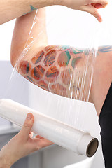 Image showing Securing tattoo stretch film