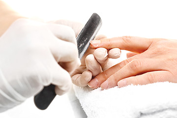 Image showing Sawing nails, manicure . Treatment hand and nail care, the woman to a beautician for a manicure.