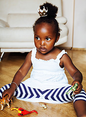 Image showing little cute african american girl playing with animal toys at ho