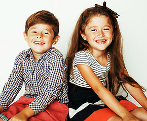 Image showing little cute boy and girl hugging playing on white background, ha