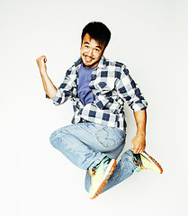 Image showing young pretty asian man jumping cheerful against white background