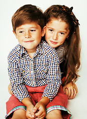 Image showing little cute boy and girl hugging playing on white background, ha