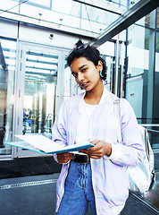 Image showing young cute indian girl at university building sitting on stairs 