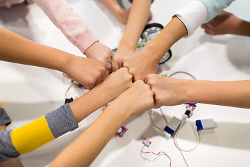 Image showing happy children making fist bump at robotics school