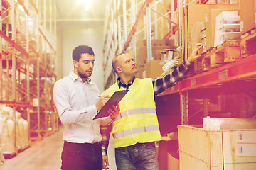 Image showing worker and businessmen with clipboard at warehouse