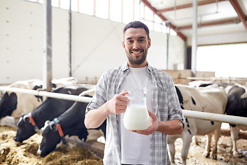 Image showing man or farmer with cows milk on dairy farm