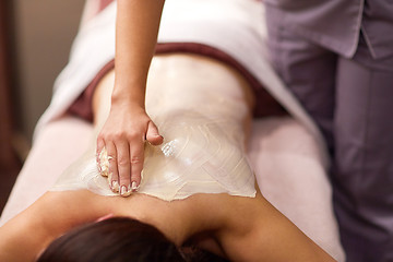 Image showing woman having back massage with cream at spa