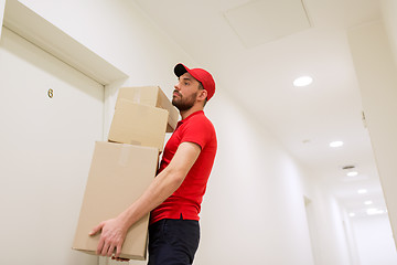 Image showing delivery man with parcel boxes at customer door