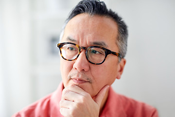 Image showing close up of asian man thinking at home