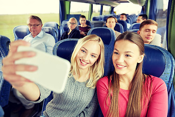 Image showing women taking selfie by smartphone in travel bus