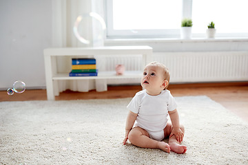 Image showing happy baby with soap bubbles at home