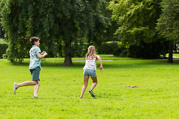 Image showing group of happy kids or friends playing outdoors