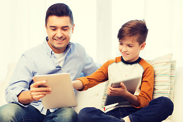 Image showing happy father and son with tablet pc at home