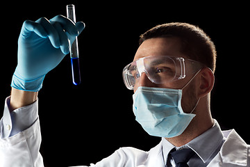 Image showing scientist with safety glasses, mask and test tube