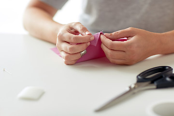 Image showing woman with needle stitching fabric pieces