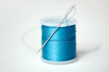 Image showing red thread spool on cloth