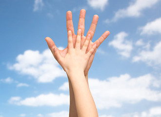 Image showing father and child holding hands together over sky