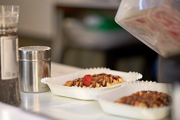 Image showing waffle with strawberry on paper plate and fork